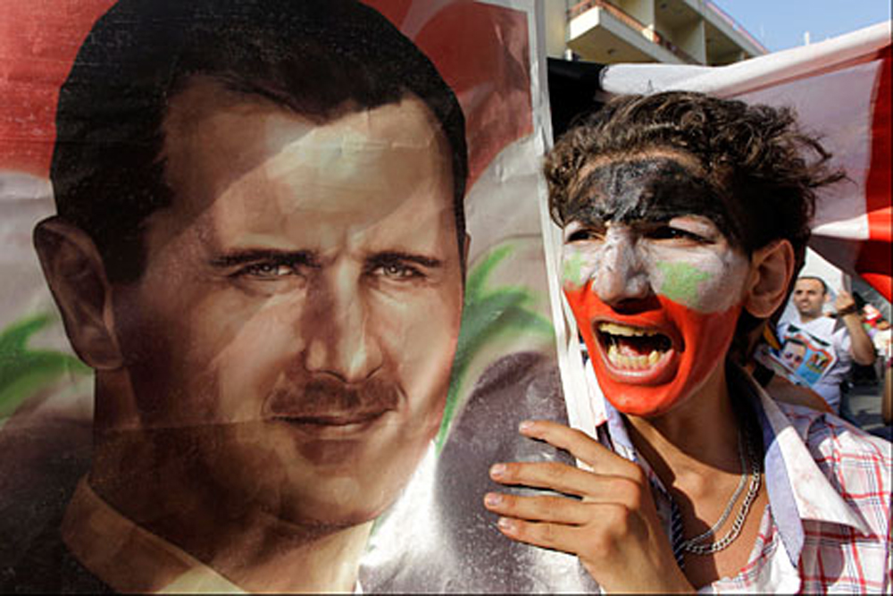 Seorang pengunjuk rasa meneriakkan dukungan terhadap Presiden Suriah Bashar Assad.