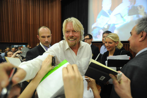 English businessman, Virgin Group chairman, Sir Richard Branson (C) signing autographs after "Future Money" conference at the Skolkovo School of Management. Source: ITAR-TASS