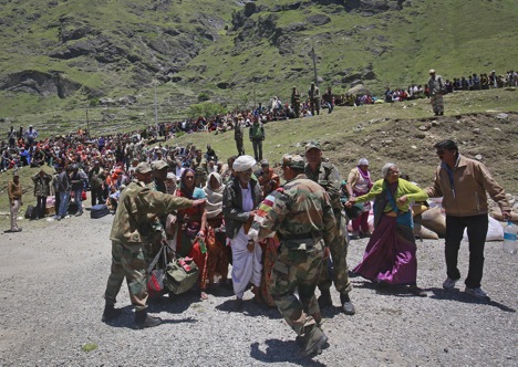 Soldiers stop survivors from going near an army helicopter as its lands during rescue operations at Badrinath in the Himalayan state of Uttarakhand June 21, 2013. Source: Reuters/Danish Siddiqu
