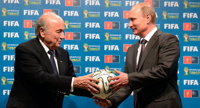 FIFA President Sepp Blatter and Russian President Vladimir Putin hold a soccer ball during the official ceremony of handover to Russia as the 2018 World Cup hosts, July 13, 2014. Source: AP 