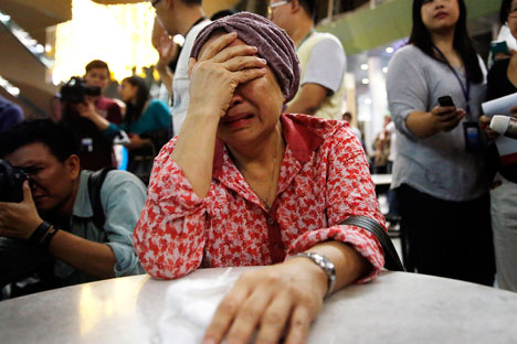 A woman cries at Kuala Lumpur International Airport as she waits for more information about the crashed plane, on July 18. Source: Reuters