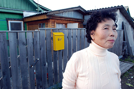 Pak Den Dya, an ethnic Korean living on Russia's Sakhalin Island, poses in front of her home in Yuzhno-Sakhalinsk, Russia. Source: AP Photo/Burt Herman