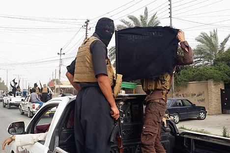 ISIS fighters celebrate on vehicles taken from Iraqi security forces, on a street in the Iraqi city of Mosul, June 12, 2014. Source: Reuters
