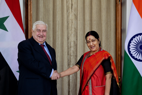 Syrian Deputy Prime Minister and Foreign Minister Walid Al Moualem, left, shakes hands with Indian External Affairs Minister Sushma Swaraj in New Delhi, India, Tuesday, Jan. 12, 2016.
