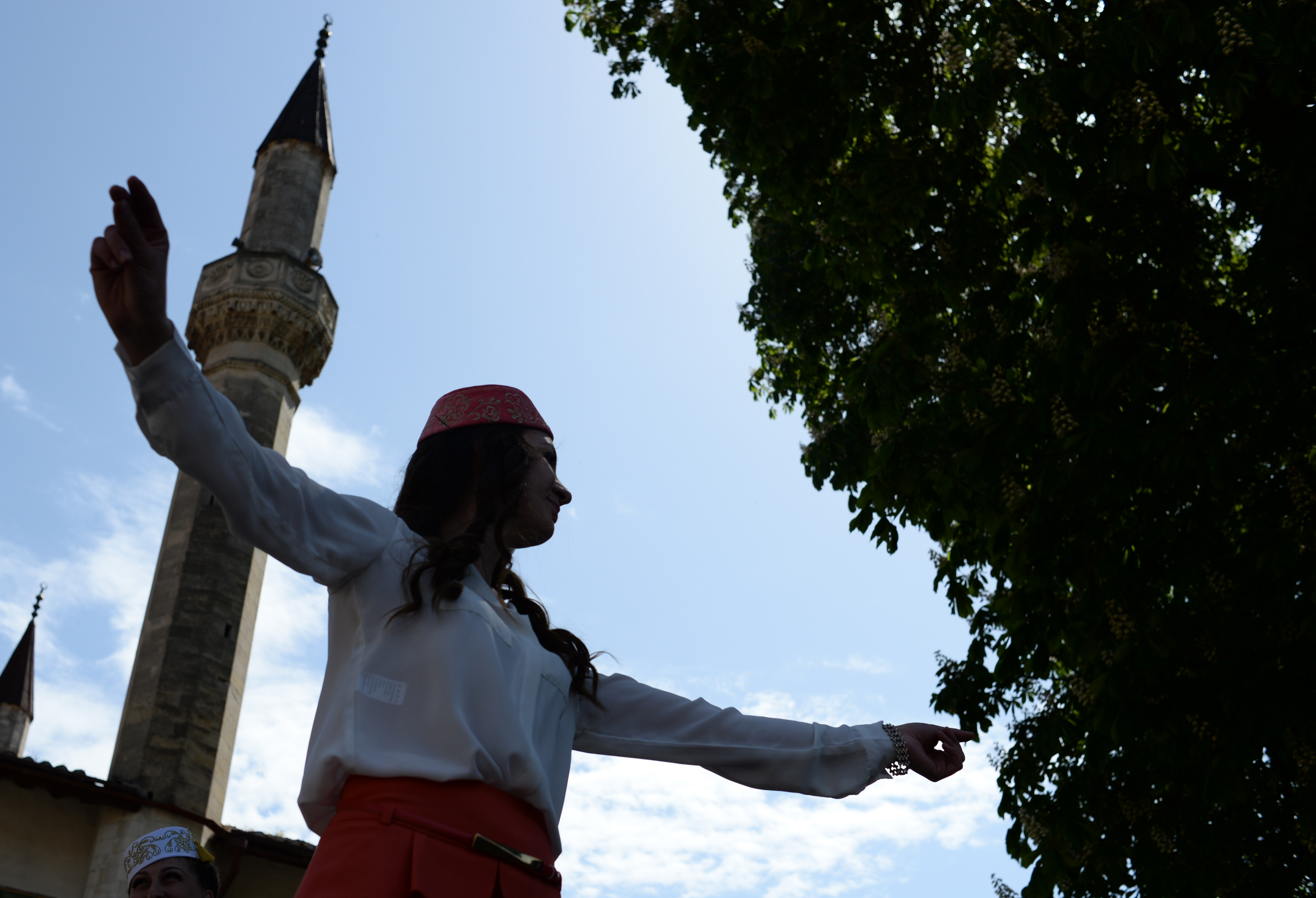 A young woman performs traditional dance of the Crimean Tatars.
