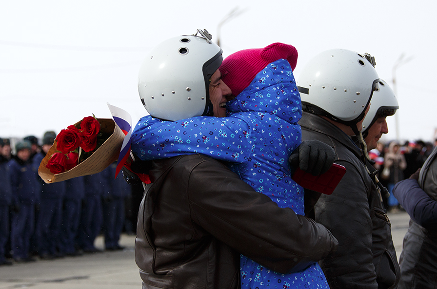 A Russian pilot receives a welcome on returning from Syria at an airbase near the Russian city of Voronezh, March 15, 2016. 