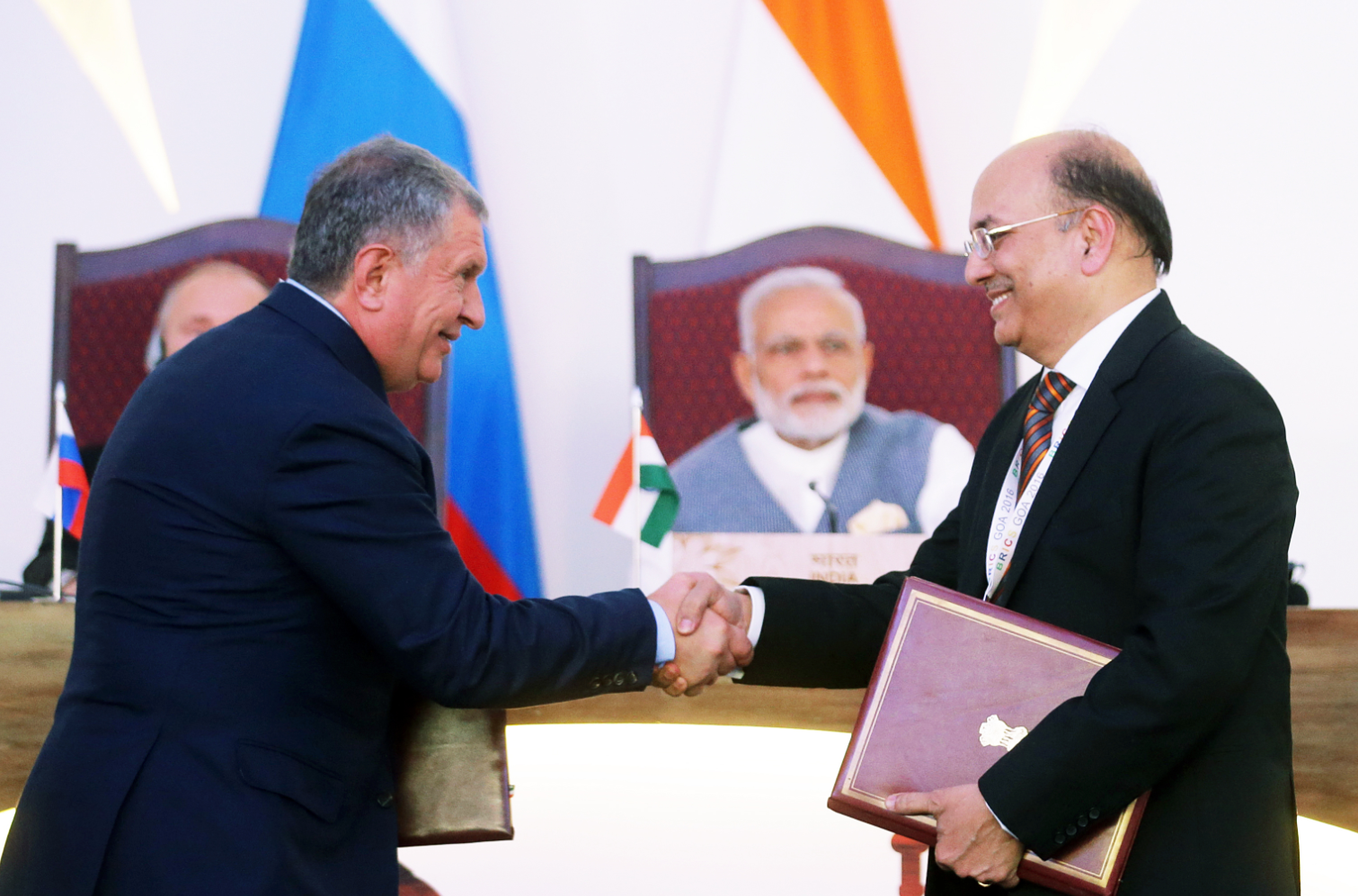 Rosneft oil company CEO Igor Sechin, left, and Narendra Verma, Managing Director of ONGC Videsh Limited, at the ceremony of signing documents attended by Russian President Vladimir Putin and Indian Prime Minister Narendra Modi in Goa, India, Oct. 15, 2016.
