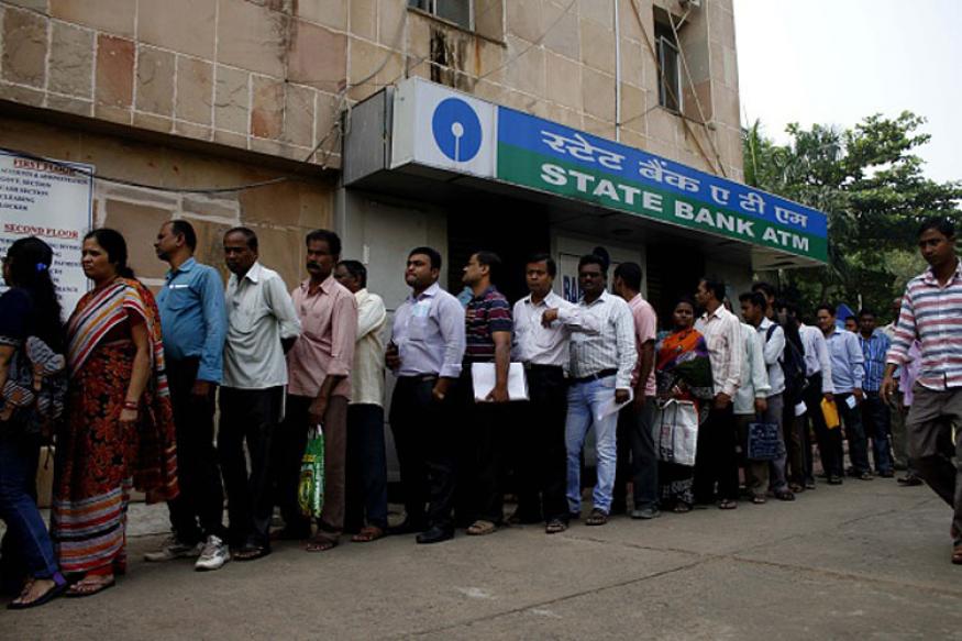People stand in the queue to enter into the bank to withdraw money and exchange the discontinued notes in Bhubaneswar, India, November 11, 2016.