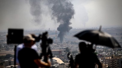 Журналисты снимают пожар, устроенный террористами в сирийском городе Рас эль-Айн